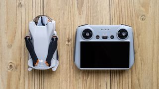 DJI Mini 3 folded next to its controller