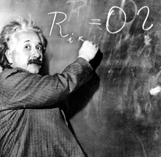 einstein writing an equation on chalkboard