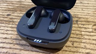 JBL Live Pro 2 earbuds close-up of case on brown table