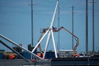 Crews work on the former Mr. Steven's arms.