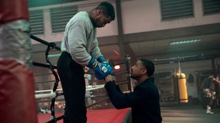 Damian bumps fists with Adonis in Creed 3