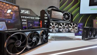 Three RTX 5090 graphics cards on display at the Asus suite, CES 2025.