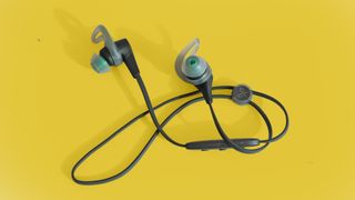 Best running headphones Jaybird X4 on a yellow surface