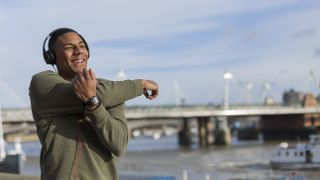 Can music influence your workout? Image shows person stretching before working out