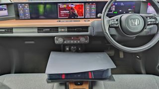 PS5 in Honda e with Deathloop on screen