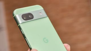 Google Pixel 8a in aloe green showing