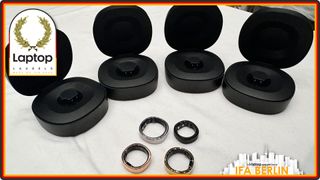 Various sizes of the RingConn Gen 2 Smart Ring pictured along with their cases on a table at at IFA 2024