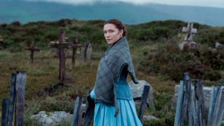 Florence Pugh as Lib Wright turning to look at the camera in a graveyard.