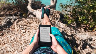 Man reading on Kindle