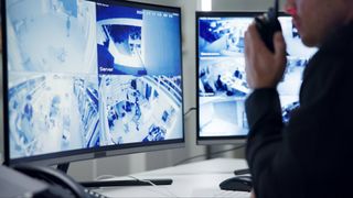 person monitoring CCTV systems