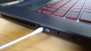 A cotton swab next to a laptop port