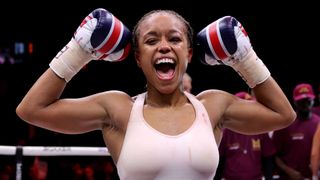 Natasha Jonas holds her fist in the air in celebration.