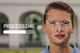 Concept image of a person having their face scanned, indicating the risk of identity theft.