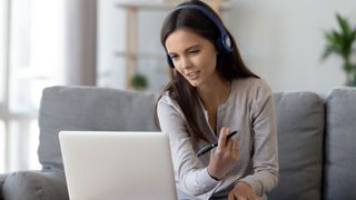 A woman using a laptop to work from home.