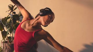 Cambridge Audio Melomania P100 worn by a female dance student, wearing a red top