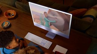 Children watching a cartoon on an Apple iMac M4