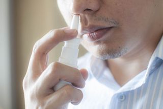 Man using nasal spray