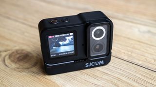 SJCAM SJ20 Dual Lens Action Camera on a wooden floor