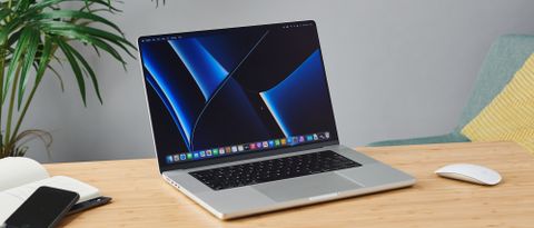 MacBook Pro 16-inch on wooden table in modern office