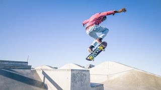 Skateboarder doing a trick in a skate park