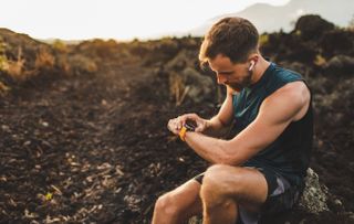 Runner with smartwatch and earbuds