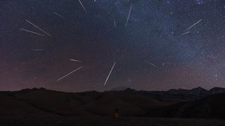 A long-exposure photo showing many meteors streaking across the night sky