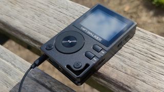 The HiFi Walker H2 on a wooden bench.