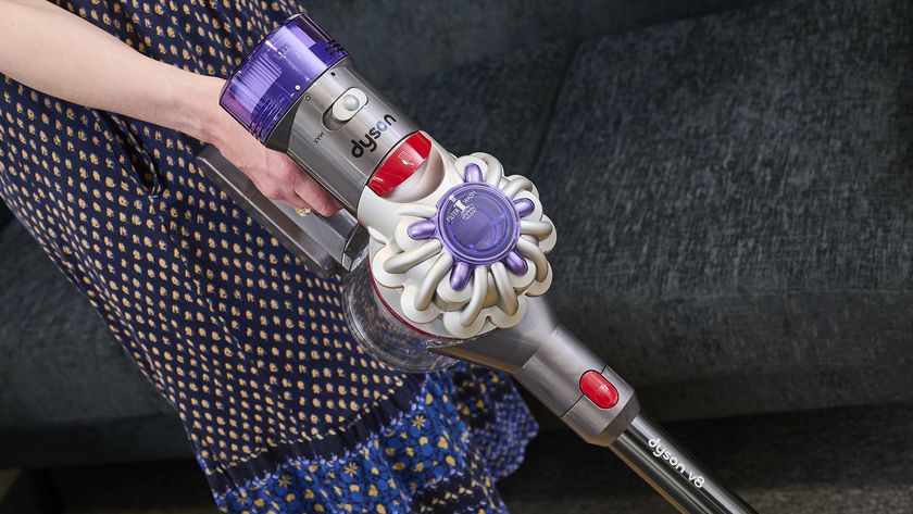 Person using Dyson V8 vacuum