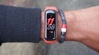 A Samsung Galaxy Fit 2 on someone's wrist