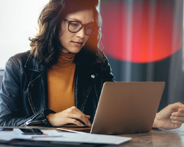 Business woman working on a laptop in a professional office