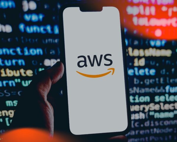 person with phone and AWS logo