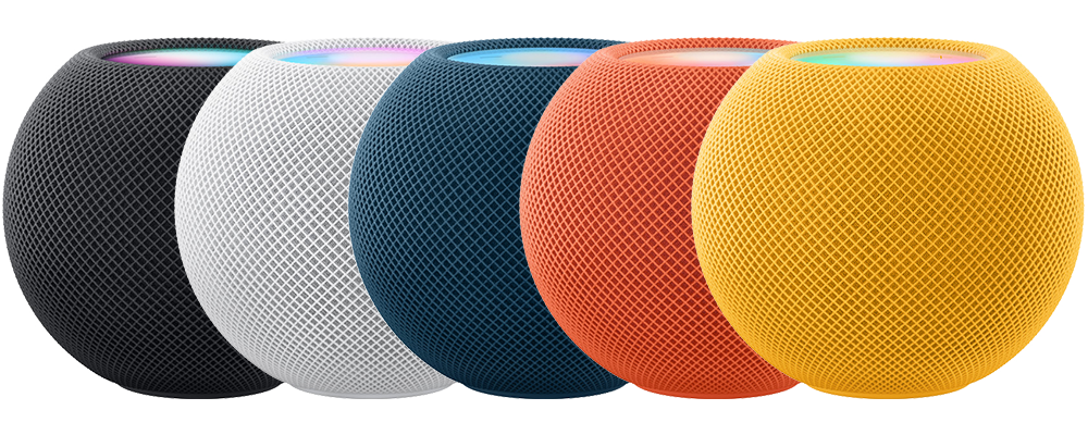 Five HomePod mini devices in a row. Space gray, white, blue, orange, and yellow. Midnight is not shown.