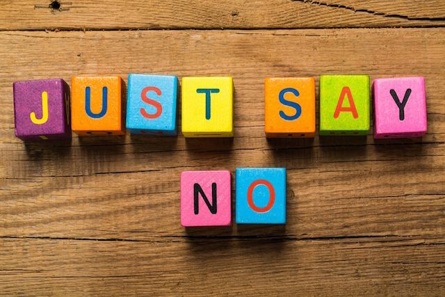 A wooden table with blocks that spell out just say no.