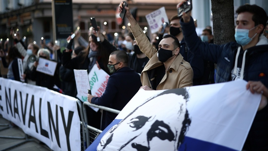 Photo: Protesters hold their lit up mobile phones as they demonstrate in support of jailed Russian opposition politician Alexei Navalny outside the Russian Embassy in London, Britain, April 21, 2021. Credit: REUTERS/Henry Nicholls.