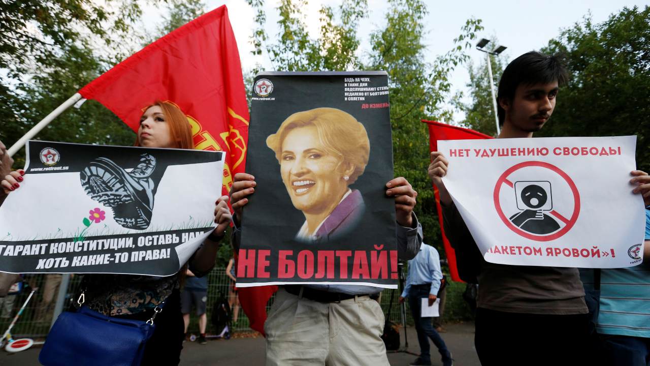 Photo: People carry signs as they protest against new anti-terrorism legislation approved by President Vladimir Putin that critics say will curb basic freedoms and make it easier for the authorities to stifle dissent, in Moscow's Sokolniki park, Russia, August 9, 2016. The signs read: "Do not talk!" (C), "Guarantor of constitution, leave us at least some of the rights" (L) and "No to choking of freedom with the package of laws by (Russian lawmaker Irina) Yarovaya" (R). Credit: REUTERS/Maxim Zmeyev