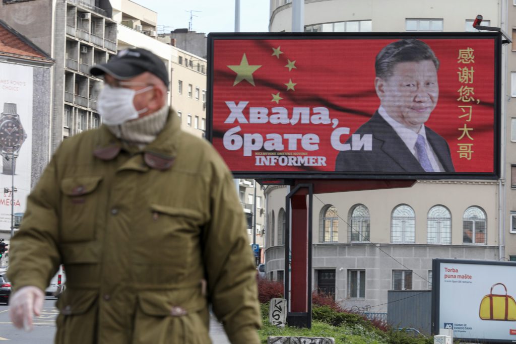 Photo: A man wearing a protective mask passes by a billboard depicting Chinese President Xi Jinping as the spread of the coronavirus disease (COVID-19) continues in Belgrade, Serbia, April 1, 2020. The text on the billboard reads "Thanks, brother Xi". Picture taken April 1, 2020. Credit: REUTERS/Djordje Kojadinovic.