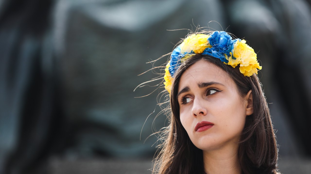 Photo: A Ukrainian woman with a crown of flowers in the colors of the Ukrainian flag takes part in the demonstration in Krakow, Poland on May 16, 2022. Credit: Jakub Porzycki/NurPhoto