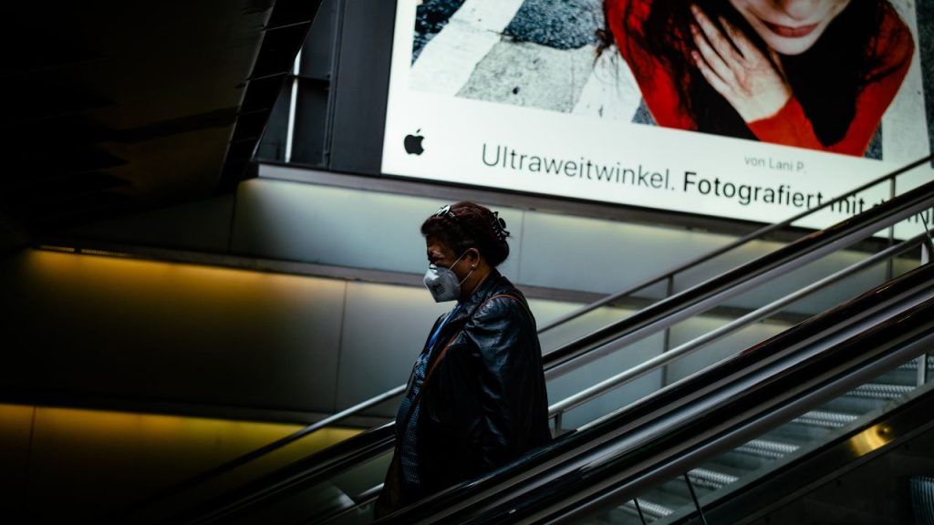 Photo: A person riding down an escalator. Credit: "covid-19" by Silvio Naef, April 24, 2020, is licensed under CC BY-ND 2.0