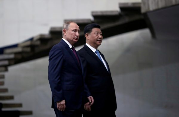 Photo: Russia's President Vladimir Putin and China's Xi Jinping walk down the stairs as they arrive for a BRICS summit in Brasilia, Brazil November 14, 2019. Credit: REUTERS/Ueslei Marcelino/File Photo