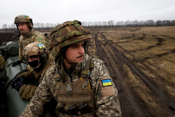 Ukrainian soldiers with the 43rd Heavy Artillery Brigade sit atop 2S7 Pion self propelled cannon on the battlefield, as Russia's attack on Ukraine continues, during intense shelling on the front line in Bakhmut, Ukraine, December 26, 2022. REUTERS/Clodagh Kilcoyne TPX IMAGES OF THE DAY