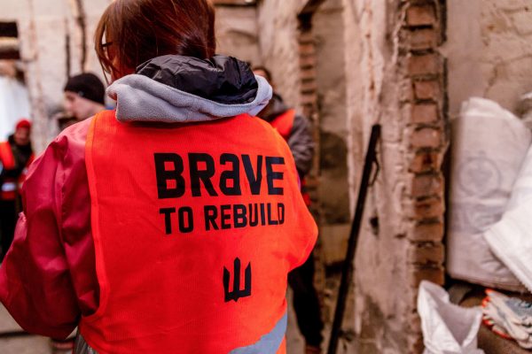 Photo: Volunteers of Kyiv NGO Brave to Rebuild start work in a building which has been bombed during Russian invasion in Irpin, Ukraine. Credit: SOPA Images Limited / Alamy Stock Photo.