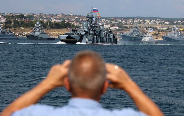 Photo: A man films Russian Navy's warships ahead of the Navy Day parade in the Black Sea port of Sevastopol, Crimea July 23, 2021. Credit: REUTERS/Alexey Pavlishak