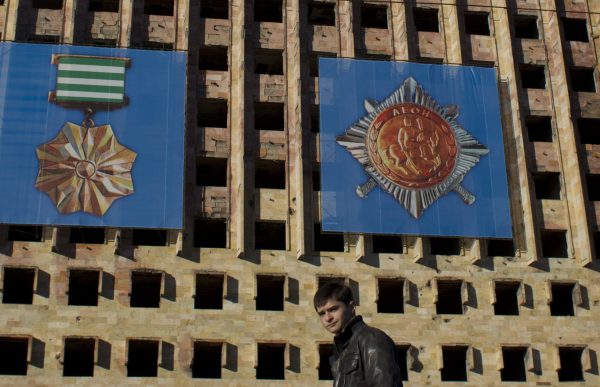 Photo: A man passes by the Council of Ministers of Abkhazia building destroyed during the 1992-1993 military conflict in Sukhumi, the capital of Georgia's breakaway region of Abkhazia December 25, 2013. The territory of Abkhazia is located several miles southwest of the border with Russia and the Olympic Park in the Adler district of the Black Sea resort city of Sochi which will host the 2014 Winter Olympic Games in February. Abkhaz separatists fought Georgian government forces in 1992-1993, after which the breakaway region declared independence. Russia, Nicaragua, Venezuela, Nauru, Vanuatu and Tuvalu recognized Abkhazia as an independent state while all other countries regard it as a Georgian province, according to local media. Picture taken December 25, 2013. Credit: REUTERS/Maxim Shemetov