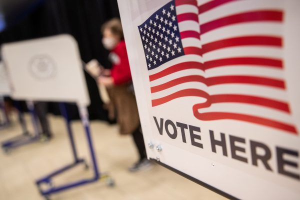 Photo: An American flag sign is seen on a voting booth at Madison Square Garden, which is used as a polling station on the first day of early voting in Manhattan, New York, US October 24, 2020. Credit: REUTERS/Jeenah Moon