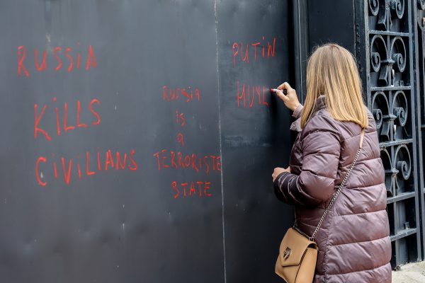 Photo: A protester uses her lipstick to write anti-Putin slogans on the door of the Russian consulate during the protest in Marseille. On the anniversary of the Russian attack on Ukraine, activists and the Ukrainian community living in Marseilles (France) gathered in front of the Russian consulate to protest against this war and hope to see an end to it. Credit: Denis Thaust / SOPA Images/Sipa USA