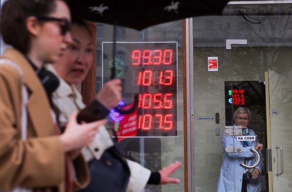 Photo: An electronic board showing currency exchange rates of the U.S. dollar and euro against Russian rouble is on display in a street in Moscow, Russia, October 6, 2023. Credit: REUTERS/Evgenia Novozhenina