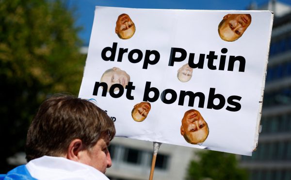 Photo: A protester holds a placard as people gather in front of the Peace Palace to call for Russian President Vladimir Putin to go to jail instead of another term in the Kremlin, on the day of Putin's swearing-in for a new six-year term as president, in The Hague, Netherlands, May 7, 2024. Credit: REUTERS/Piroschka van de Wouw