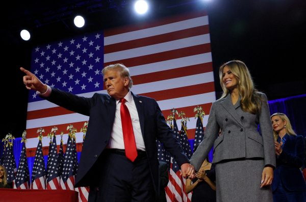 Photo: Republican presidential nominee and former US President Donald Trump gestures as he holds hands with his wife Melania during his rally, at the Palm Beach County Convention Center in West Palm Beach, Florida, US, November 6, 2024. Credit: REUTERS/Brian Snyder