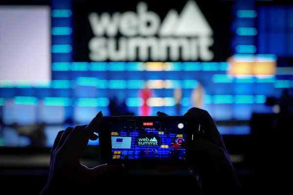 Photo: A person uses a smartphone to film at the Web Summit, in Lisbon, Portugal, November 13, 2024. Credit: REUTERS/Pedro Nunes