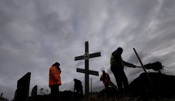 Photo: Men dig graves for victims of a Russian missile attack, amid Russia's ongoing attack on Ukraine, at the village cemetery in Hroza, near Kharkiv, Ukraine, October 9, 2023. Credit: REUTERS/Thomas Peter